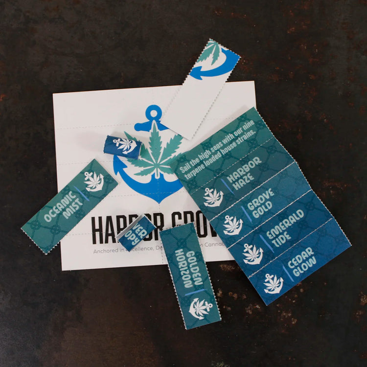 Harbor Grove Crutch Card with custom tear-off tips on a dark surface, featuring nautical cannabis branding and strain names like Oceanic Mist and Grove Gold.