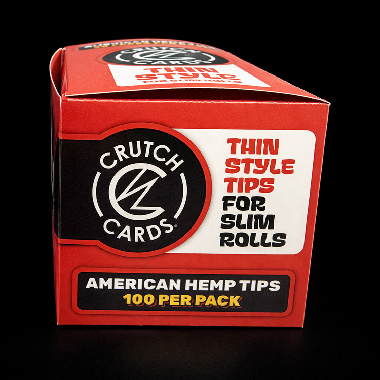 Red packaging of Crutch Cards thin style tips for slim rolls on a black background