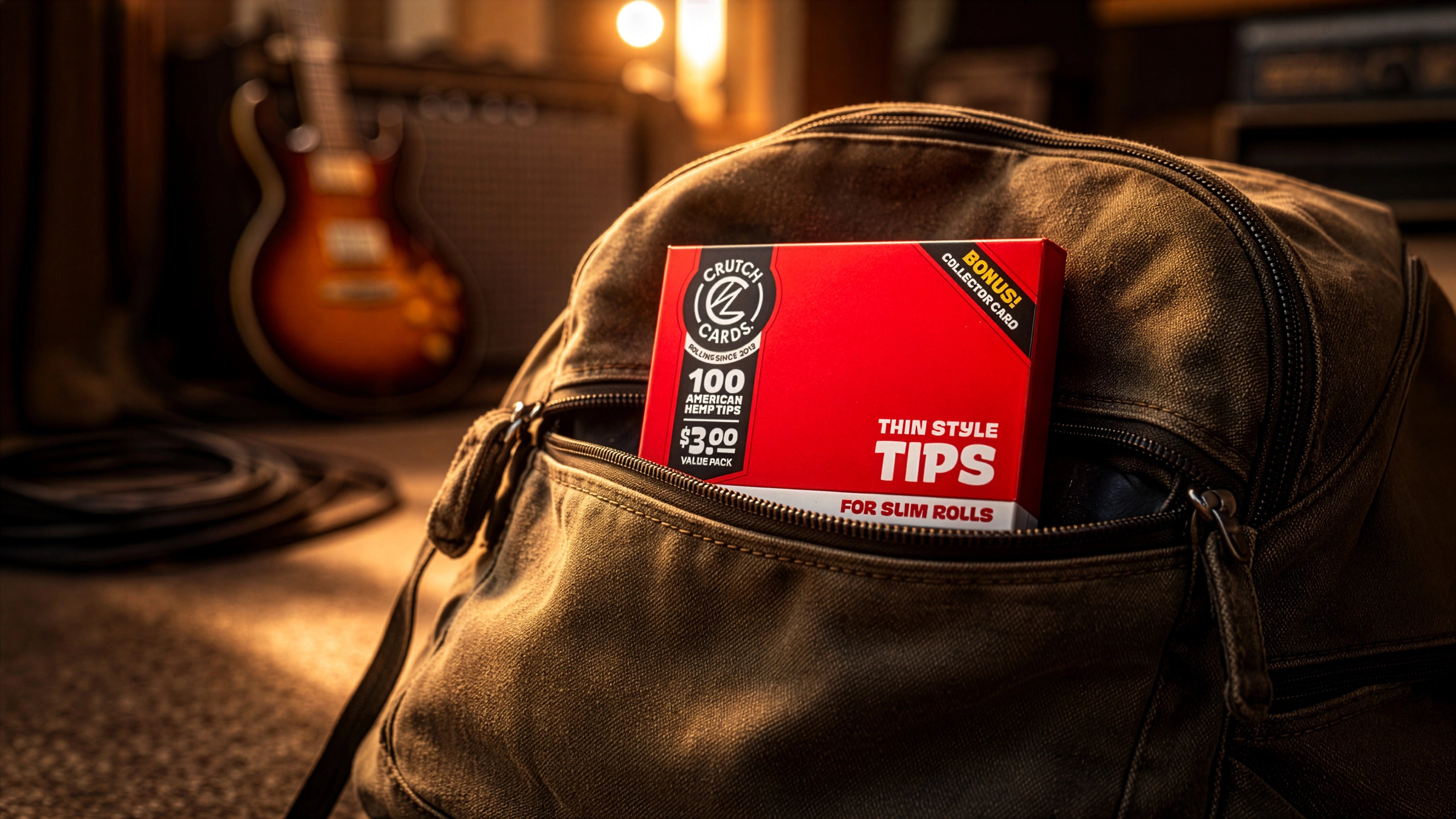 Pack of Crutch Cards Thin Style Tips in a leather bag with a guitar and amplifier in the background